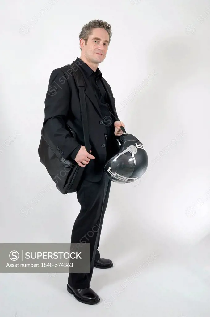 Business man carrying a motorcycle helmet