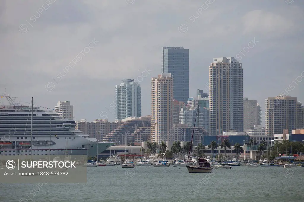 Cruise ship Carnival Valor in the harbour and the skyline of downtown Miami, Florida, USA
