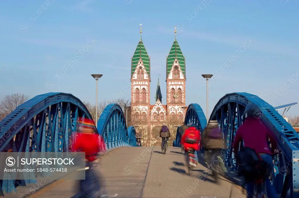 Blue Bridge and cyclists with motion blur, Freiburg im Breisgau, Black Forest, Baden-Wuerttemberg, Germany, Europe
