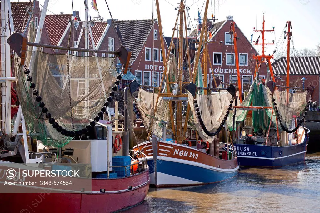 Fishing boats and shrimp boats in the old fishing port of Neuharlingersiel, East Frisia, Lower Saxony, Germany