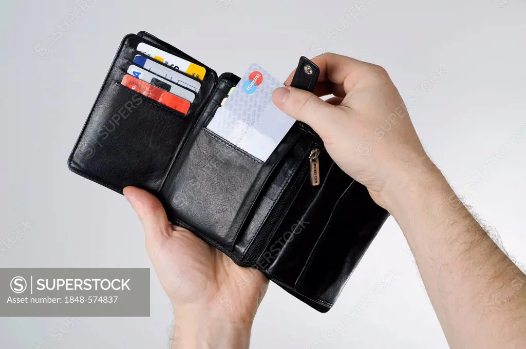 Hands holding a wallet with bank cards