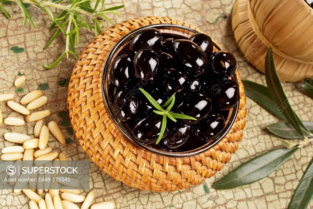A bowl of black olives on a table