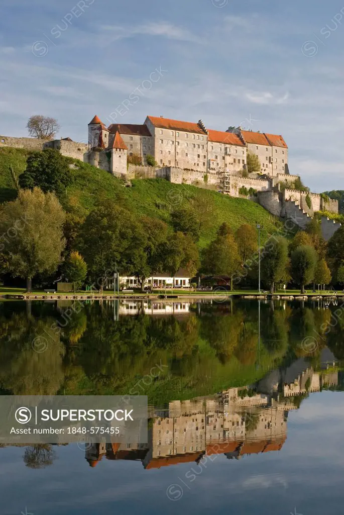 Burghausen Castle reflected in the calm Lake Woehrsee, Upper Bavaria, Germany, Europe