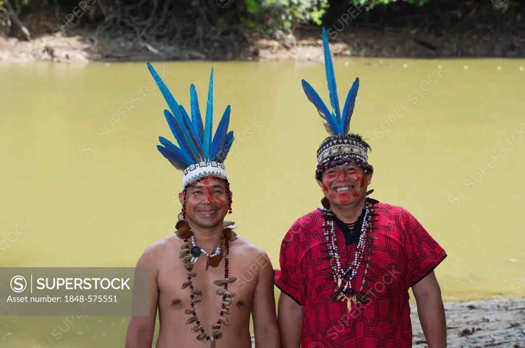 Guillermo Rodriguez Gomez, shaman of the Bora tribe, left, wearing macaw feather headdress worn during shamanic ceremonies, with assistant, northern A...