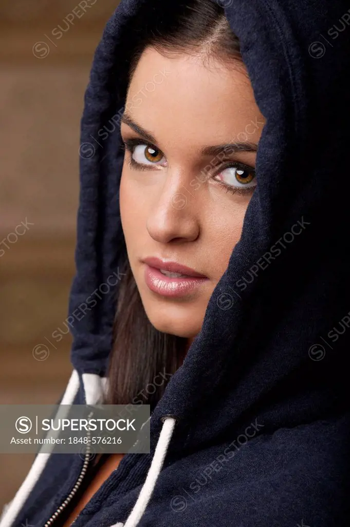 Woman wearing a hooded sweater, portrait