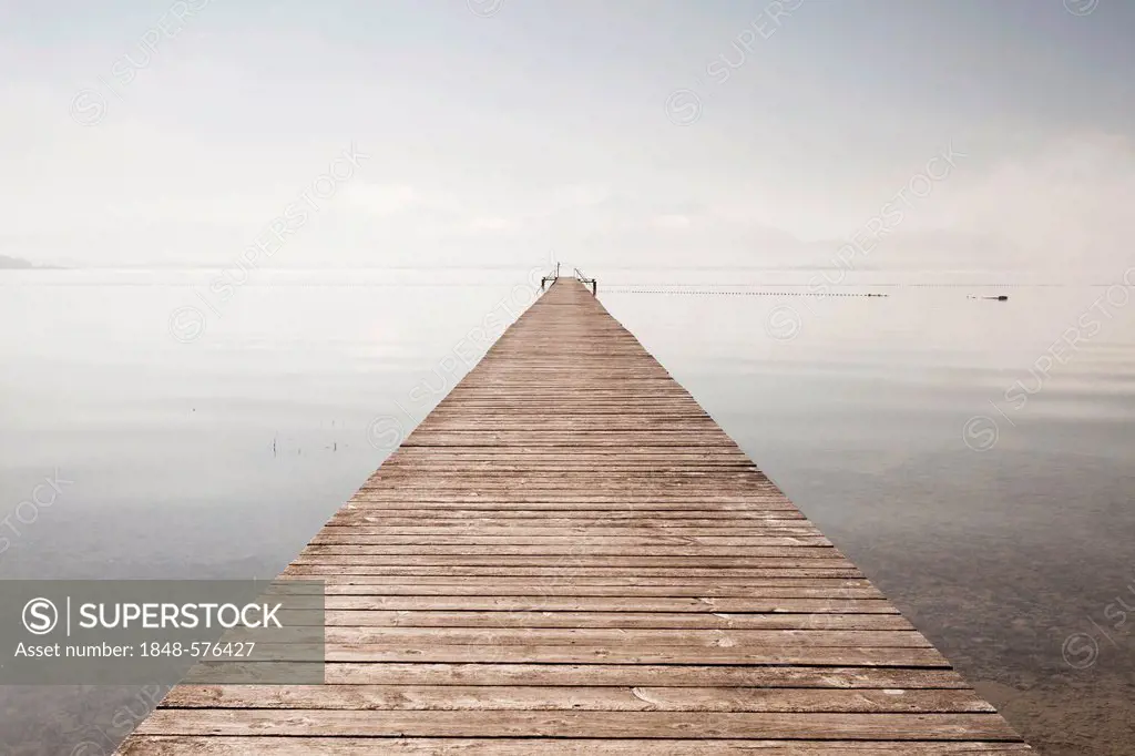 Very long jetty at Chiemsee Lake during high fog and sunshine near Seebruck, Bavaria, Germany, Europe, PublicGround