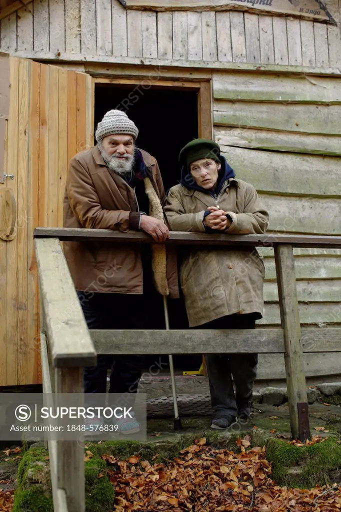 Homeless couple in front of a forest hut, in a wood near Carlsbad, Karlovy Vary, Czech Republic, Europe