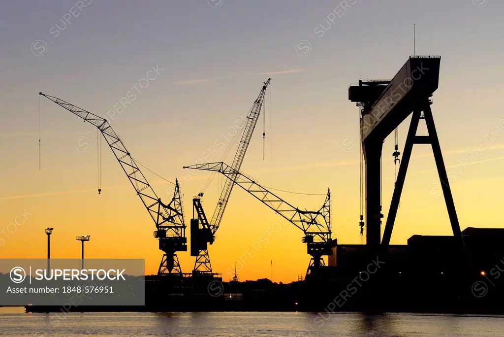 Cranes of the HDW shipyard, Howaldtswerke-Deutsche Werft GmbH, in cooperation with Thyssen-Krupp Marine Systems AG, morning mood, Kiel, Schleswig-Hols...