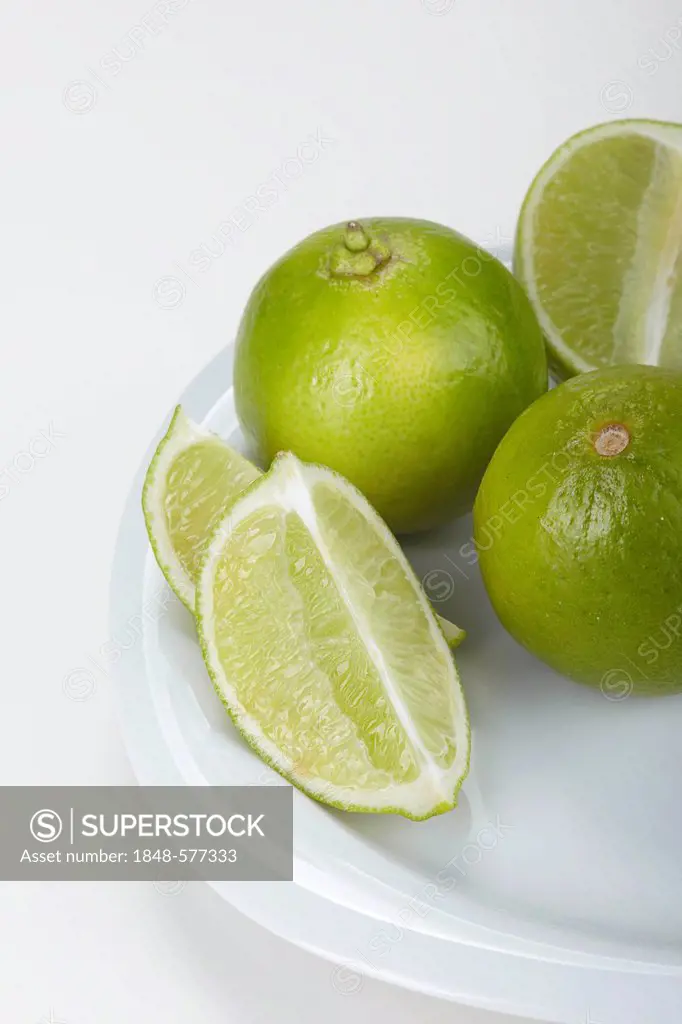 Limes (Citrus latifolia) on a white plate