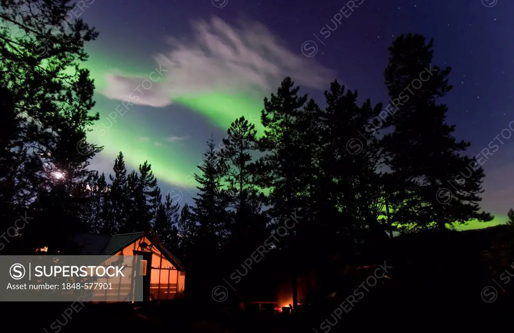 Illuminated wall tent, cabin with swirling Northern lights, Polar Aurorae, Aurora Borealis, green, near Whitehorse, Yukon Territory, Canada
