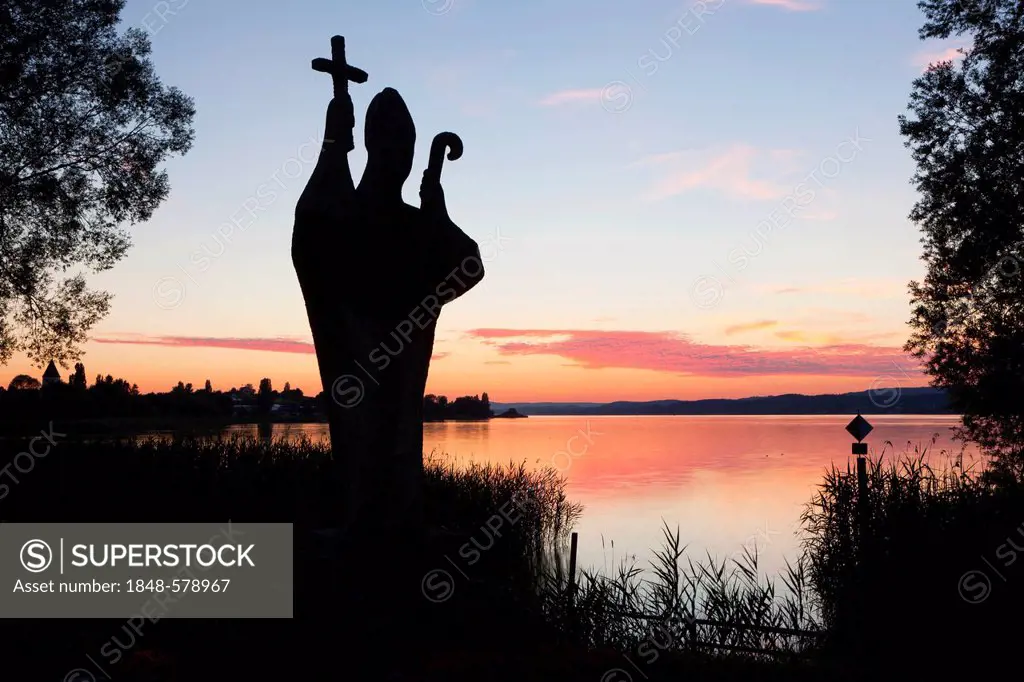 Sunset on the shore with a monument to St Pirmin on Reichenau island, Lake Constance, Baden-Wuerttemberg, Germany, Europe