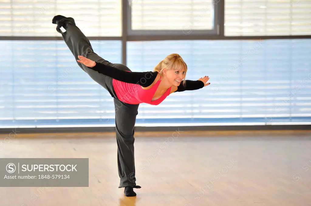 Young woman stretching, balance exercises, yoga, warming up exercises, Haus des Sports, House of Sport, SpOrt, Stuttgart, Baden-Wuerttemberg, Germany,...