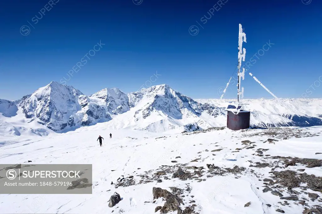 Ski mountaineers on the summit of Mt Hintere Schoentaufspitze or Punta Beltovo di Dentro, weather station, Sulden, Solda in winter, Mt Gran Zebru, Mt ...
