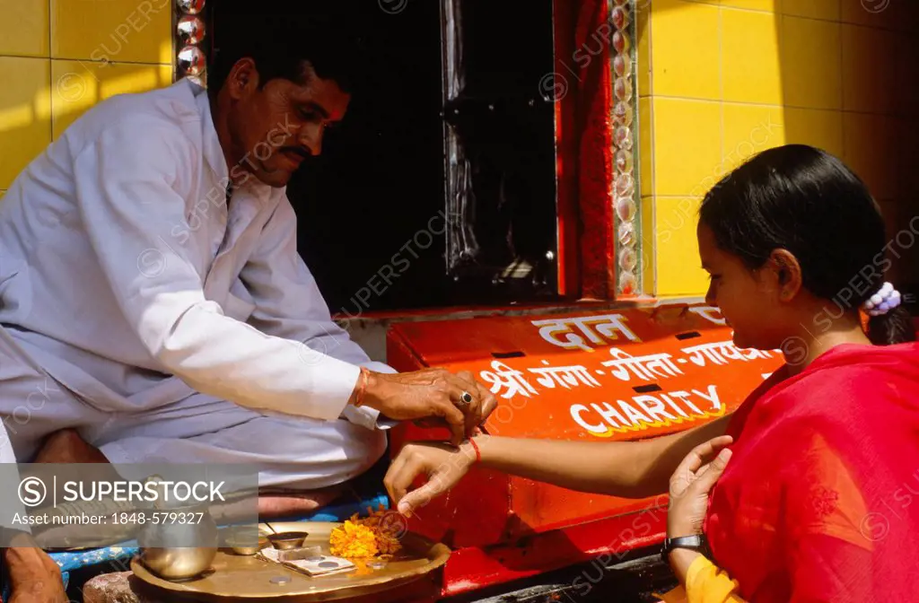 Priest exchanging blessings with donations at Har Ki Pauri Ghat in Haridwar, Uttarakhand, formerly Uttaranchal, India, Asia