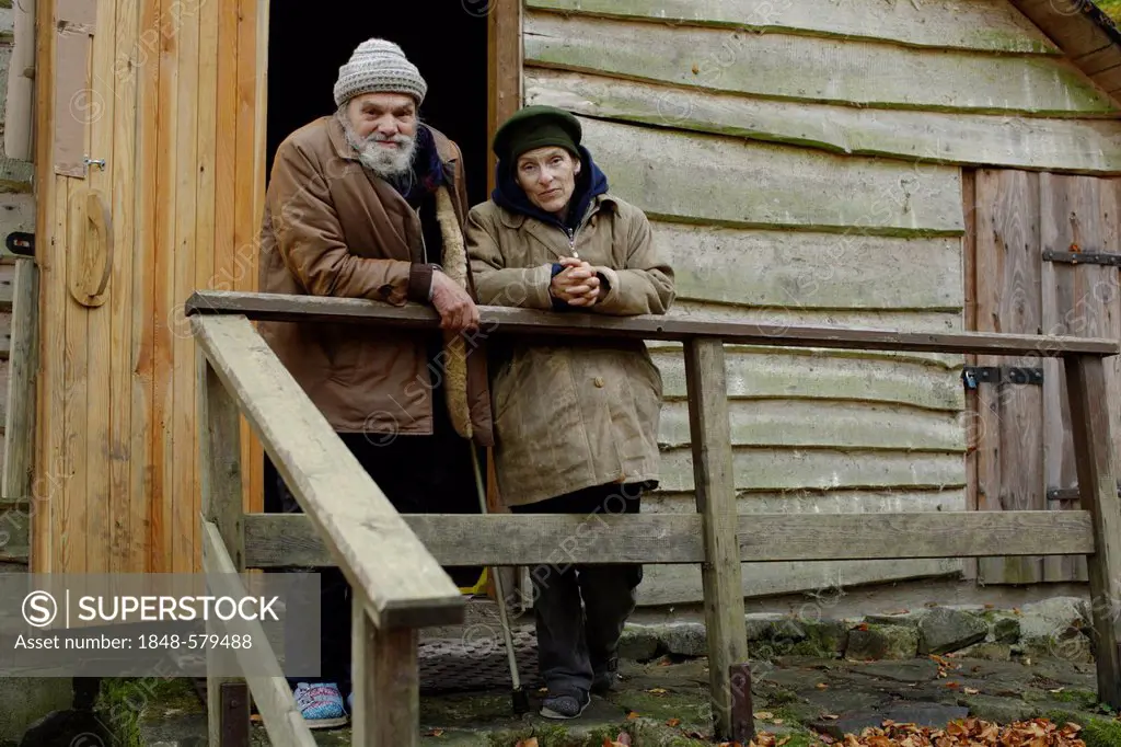 Homeless couple in front of a forest hut, in a wood near Carlsbad, Karlovy Vary, Czech Republic, Europe