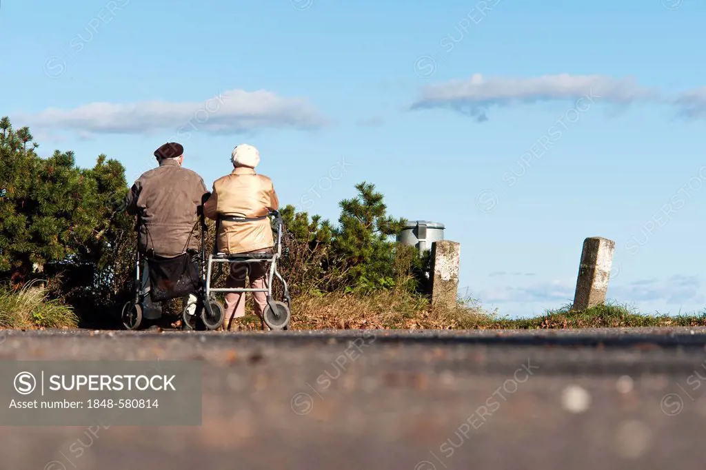 An elderly couple sitting on their Zimmer frames on the shore of the Baltic Sea, Travemuende, Schleswig-Holstein, Germany, Europe
