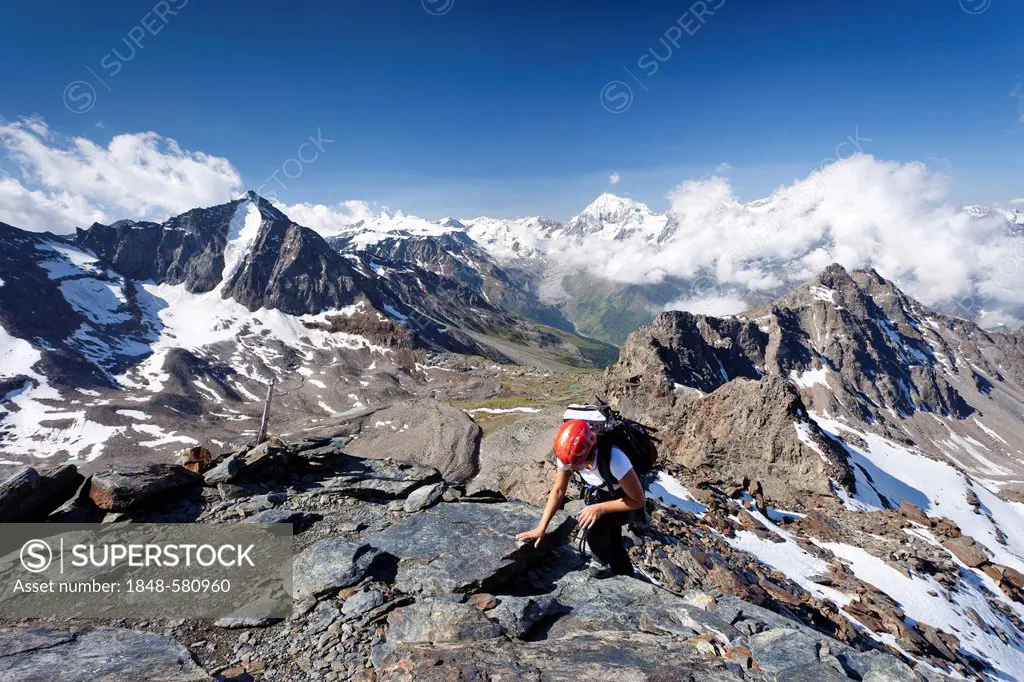 Climber at the via ferrata to Mt Croda di Cengles, above the Rifugio Serristori, in Solda, Sulden, Mt Cima Vertana and Mt Gran Zebru in the back, Val ...