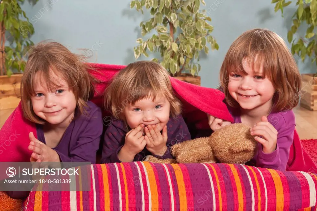 Girls, twins, six years, and three-year-old girl in the middle