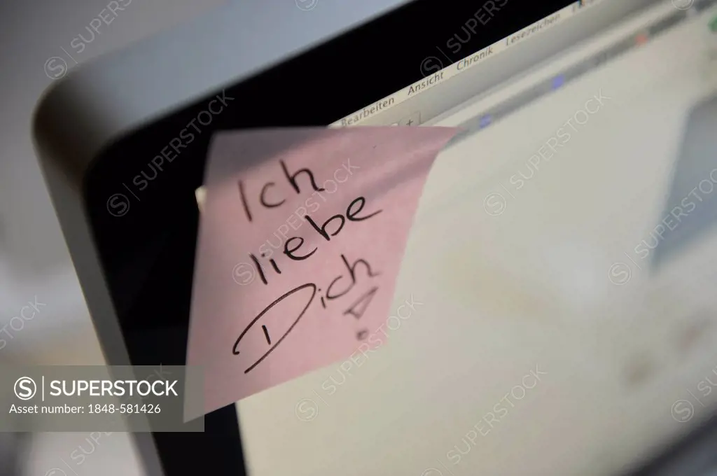 Sticky note with the words Ich liebe Dich, German for I love you, on a computer screen, symbolic image for love at the workplace