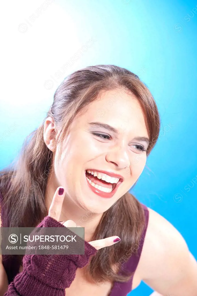 Young woman, laughing, with a cool gesture