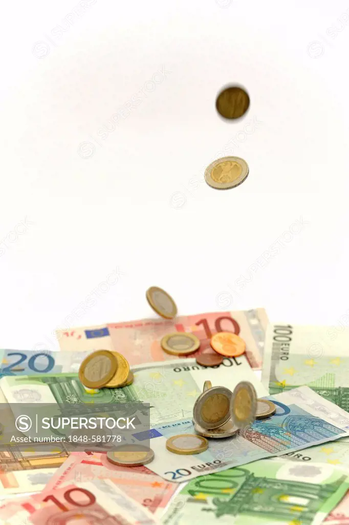 Euro coins falling onto Euro banknotes, symbolic image for windfall