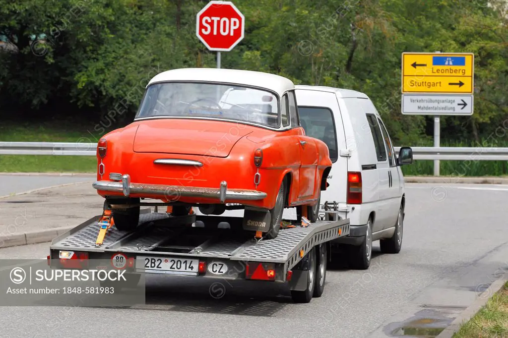 Classic car transported on a car trailer