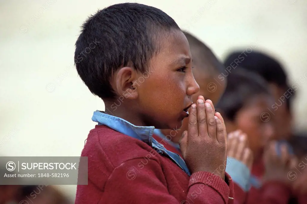 Schoolboy at the morning assembly, a boarding school in Reru near Padum, Zanskar valley, Zanskar, Ladakh, Jammu and Kashmir, Indian Himalayas, norther...