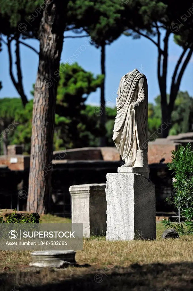 Ancient statue at the Temple of Ceres, Piazzale delle Corporazioni, Square of the Guilds or Corporations, Ostia Antica archaeological site, ancient po...