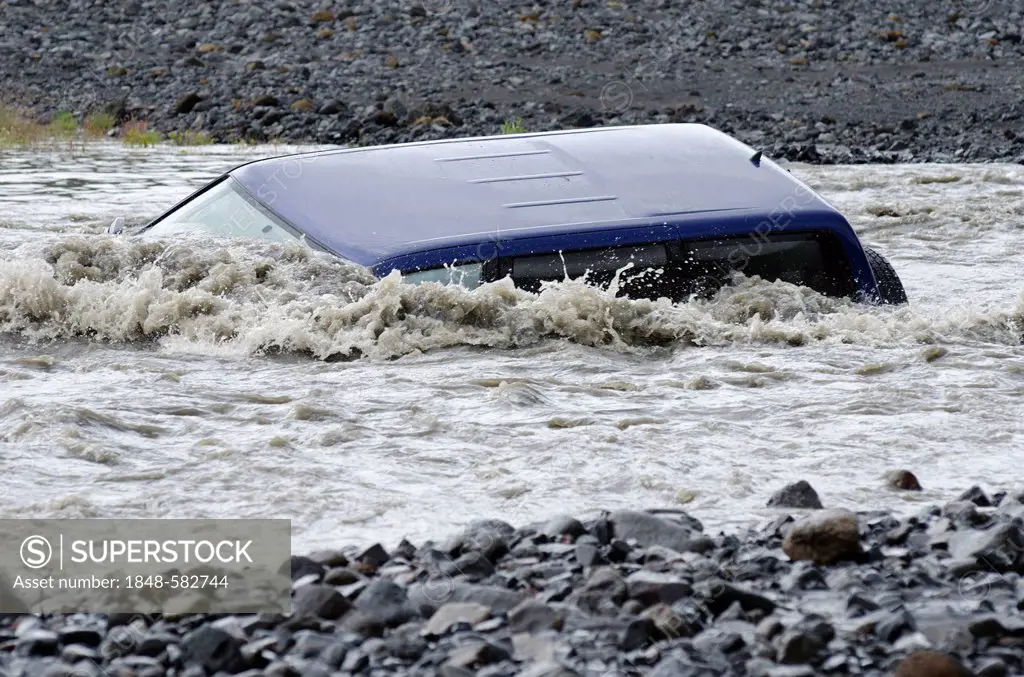 A jeep, sunk in the glacial river of Krossá, Þórsmoerk, Iceland, Europe