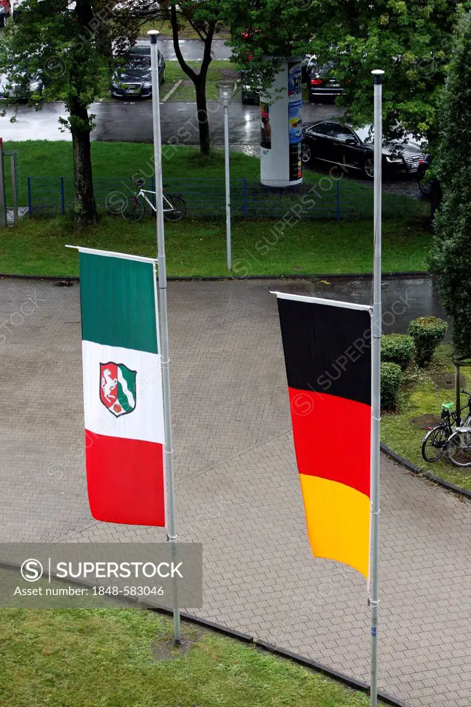 Flag of North Rhine-Westphalia and a German national flag at halfmast next to a public building, Duisburg, North Rhine-Westphalia, Germany, Europe, Pu...