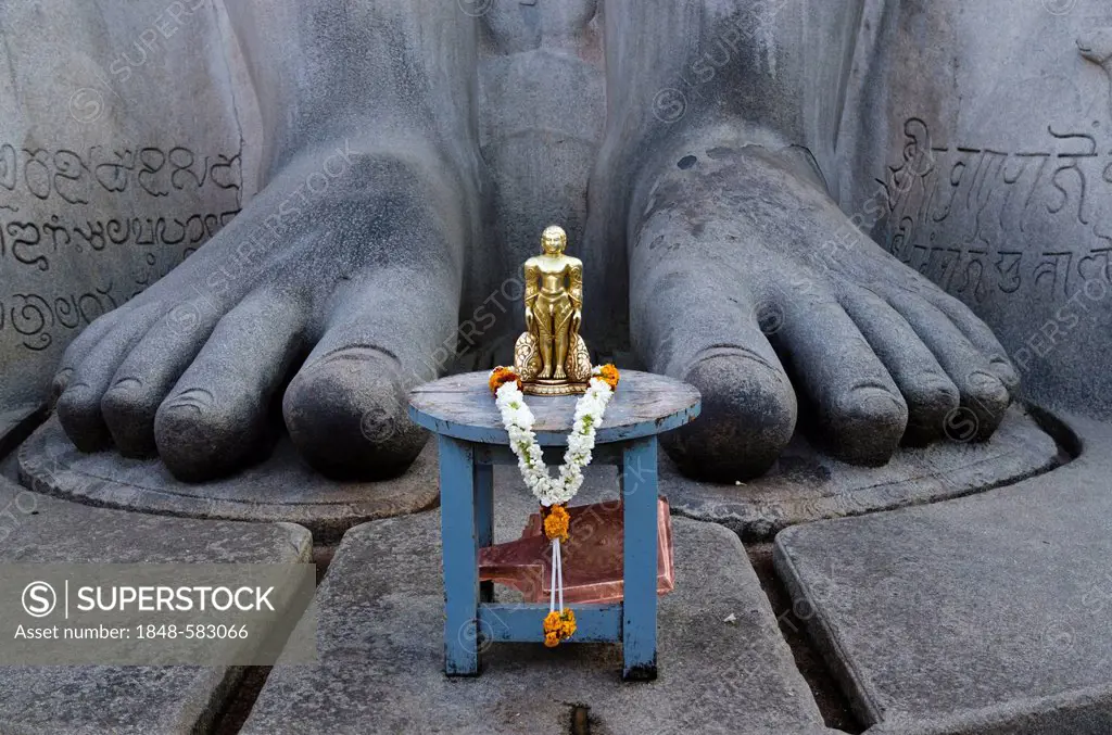 The small statue of Bahubali at the feet of the gigantic statue of Gomateshwara in Sravanabelagola, used for special rituals, Karnataka, India, Asia