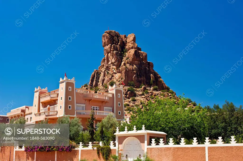 Newly built Kasbah, mud fortress, residential castle of the Berbers, Tighremt, in front of striking granite cliffs of Chapeau Napoleon, Napoleon's Hat...