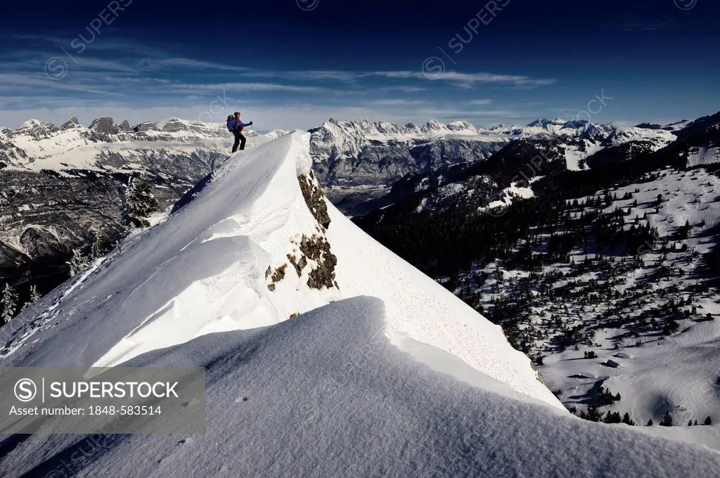 Climber on mountain top with mountain panorama, Firtzstock, Glarus, Eastern Switzerland, Switzerland, Europe