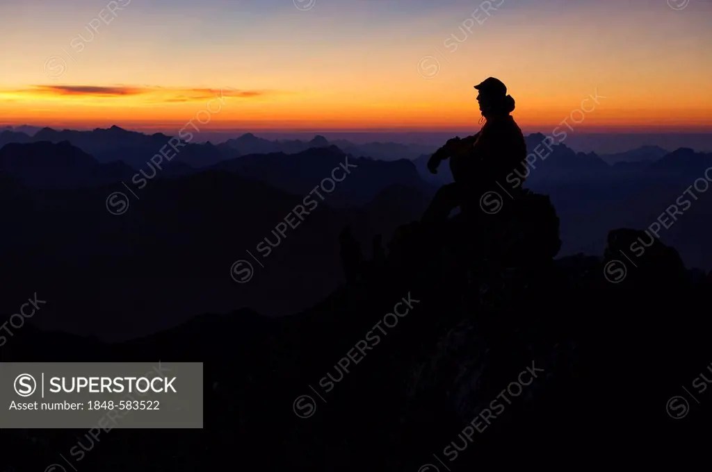 Mountain panorama with climber at sunset, Mt. Feuerspitze, Steeg, Lech, Ausserfern, Tyrol, Austria, Europe