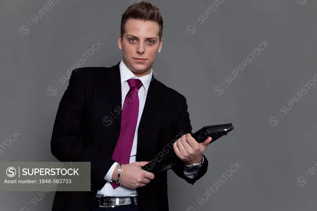 Young man in business suit and tie with notebook