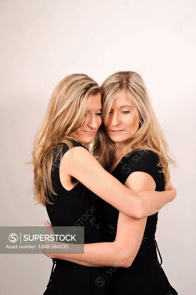 Twin sisters hugging