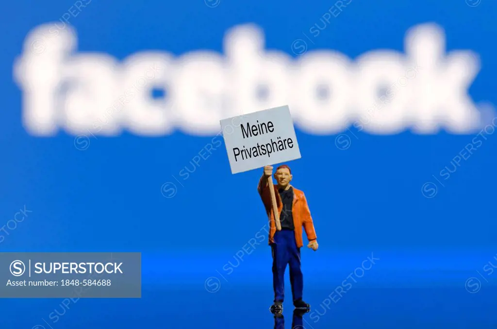 Protester holding a board, lettering Meine Privatsphaere, German for My privacy, miniature figure standing in front of a blurred Facebook logo, symbol...