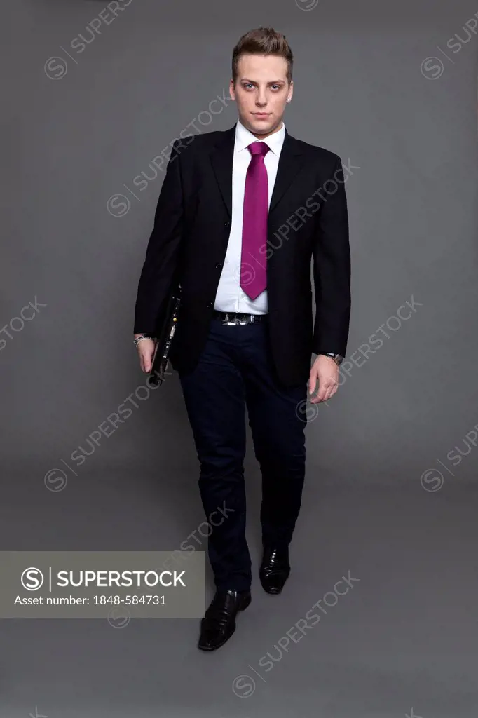 Young man in business suit and tie with notebook