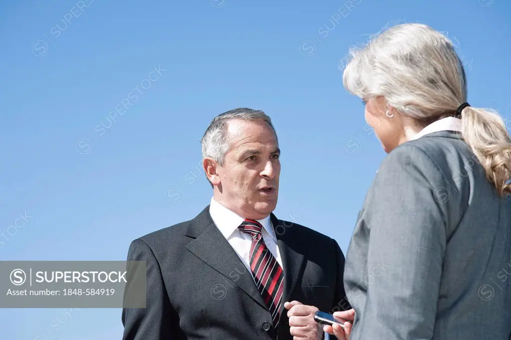 Businessman and a businesswoman having a conversation