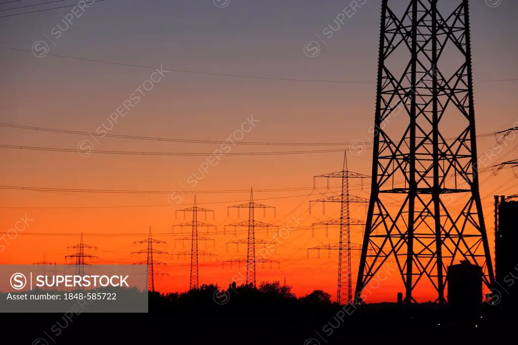 High voltage transmission lines, power lines, sunset, between Essen, Bottrop and Oberhausen, North Rhine-Westphalia, Germany, Europe