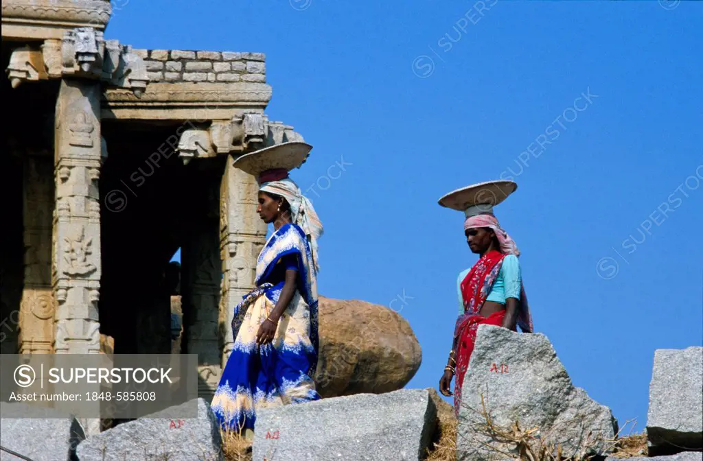 Local women restore the ruins of the old kingdom Vijayanagar, Hampi, Karnataka, India, Asia