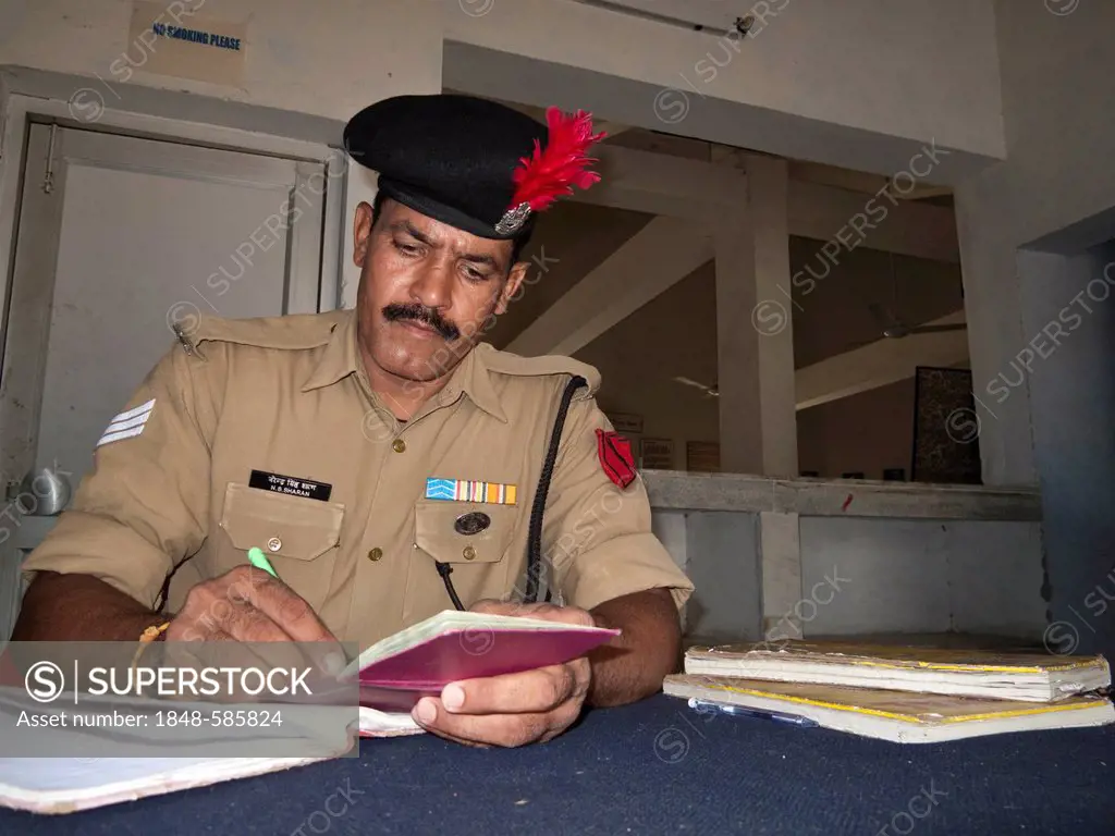 Indian security officer checking passport at border crossing, Wagah Border, Punjab, India, Asia
