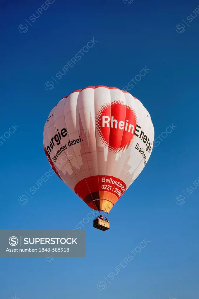Captive ballon with Rheinenergie logo climbing against blue sky
