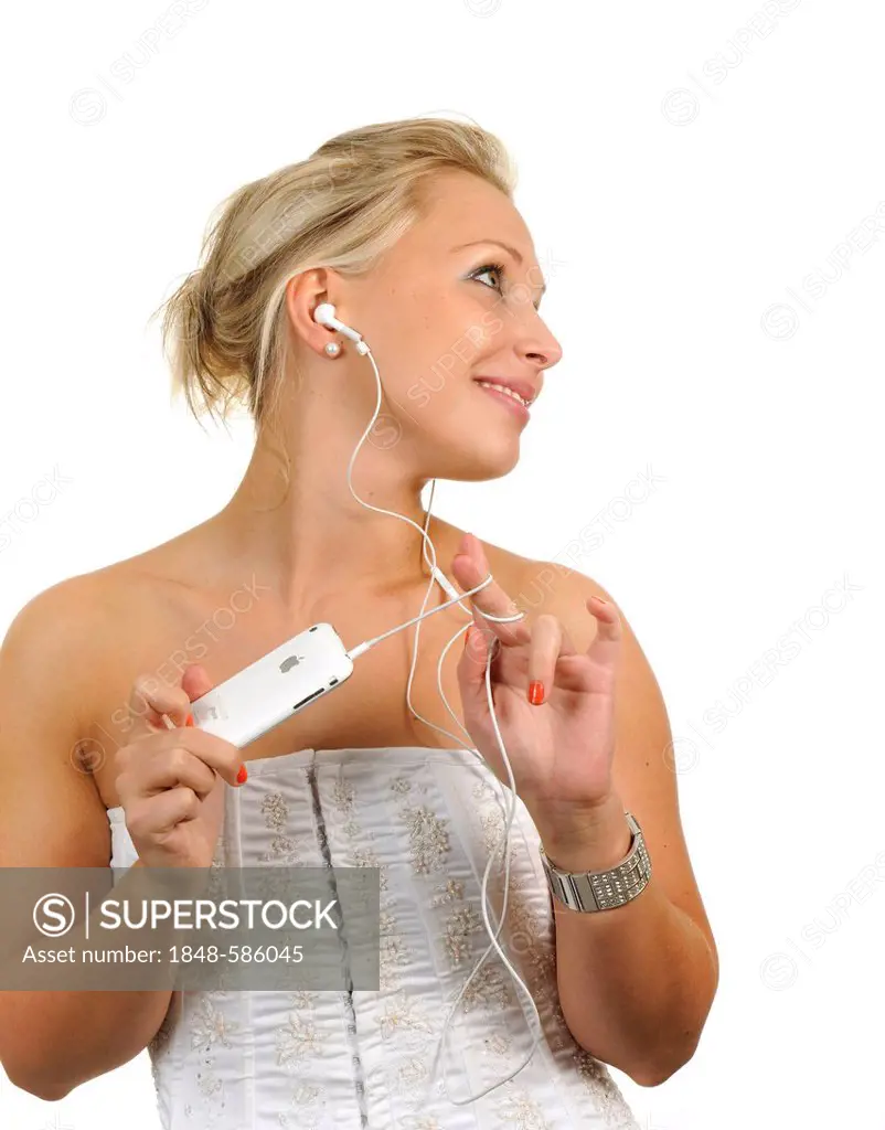 Young woman holding a white Apple iPhone, listening to music with earphones