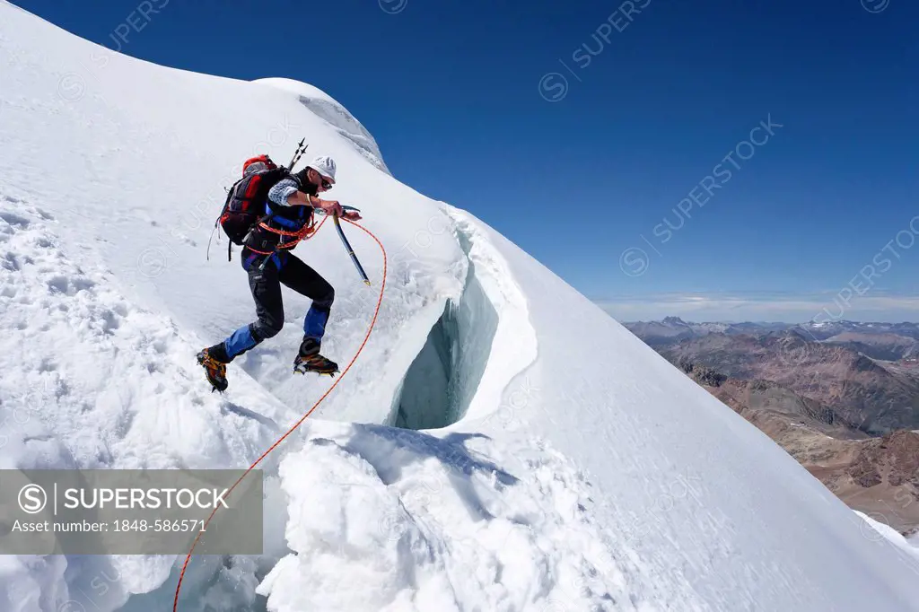 Mountaineer climbing down Piz Palue mountain, glacial landscape, canton of Graubuenden, Grisons, Switzerland, Europe