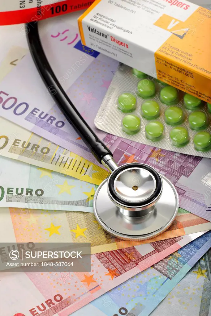 Pills and a stethoscope on a fan of euro banknotes, symbolic image of the sick euro, health care cost explosion, medical expenses