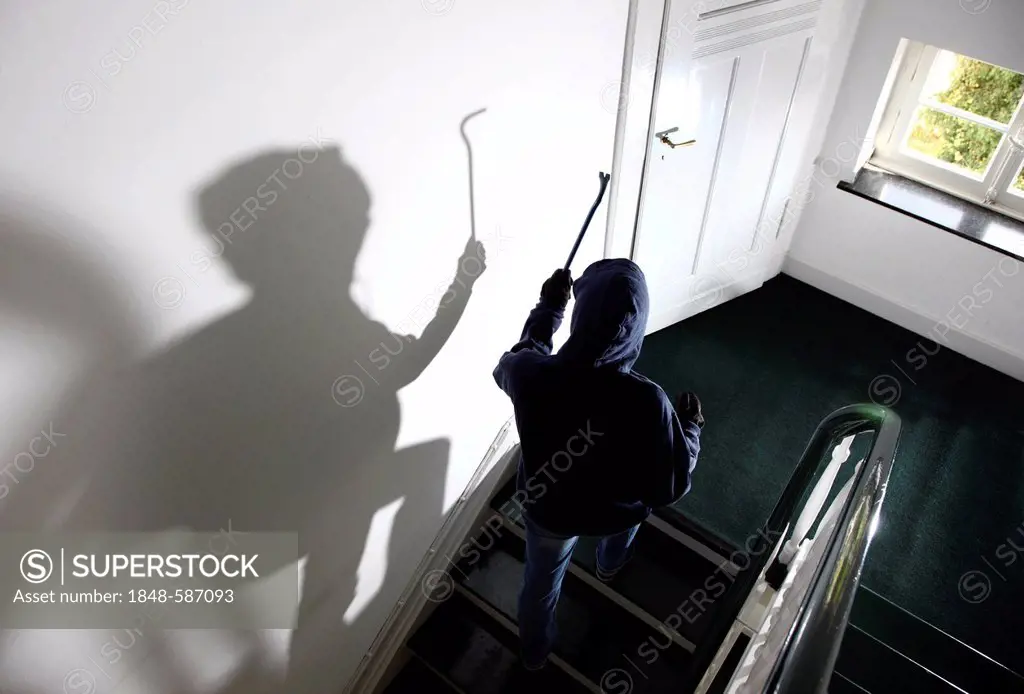 Burglary, burglar on a staircase of an apartment house during the day