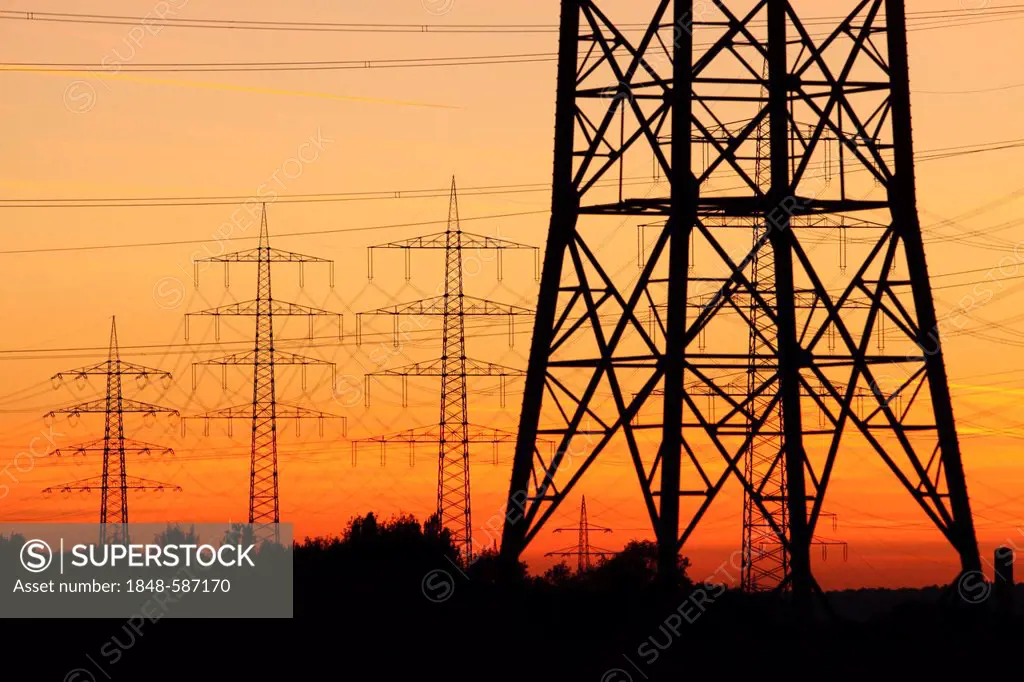 High voltage transmission lines, power lines, sunset, between Essen, Bottrop and Oberhausen, North Rhine-Westphalia, Germany, Europe