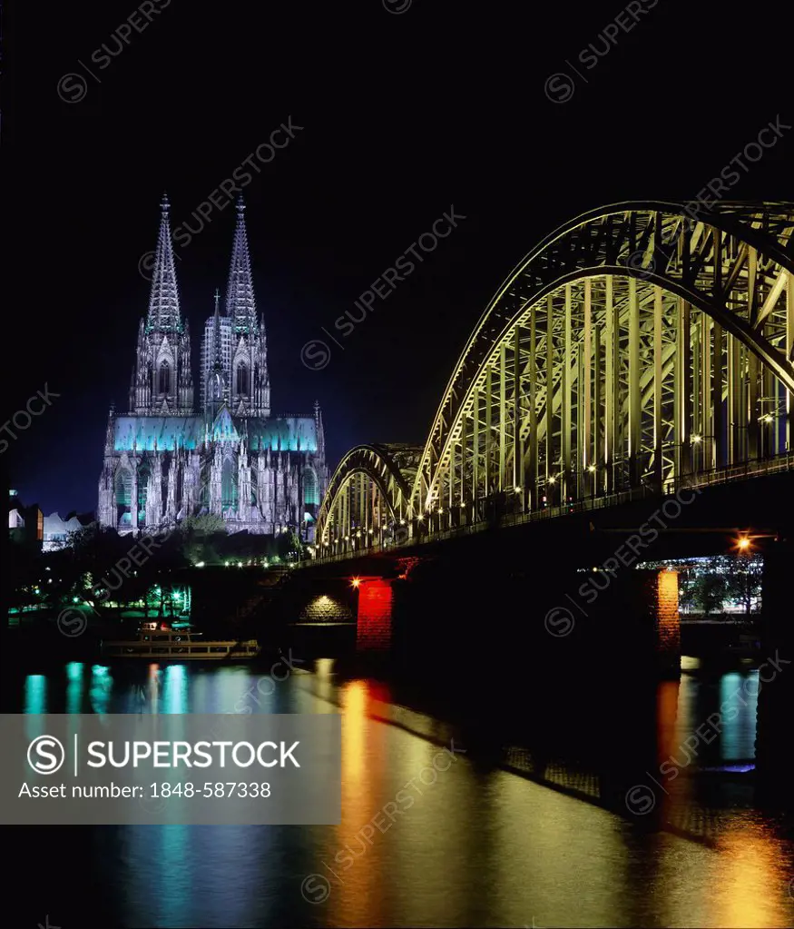 Arches of Deutz Bridge crossing the Rhine River in front of Cologne Cathedral at night, Cologne, North Rhine-Westphalia, Germany, Europe