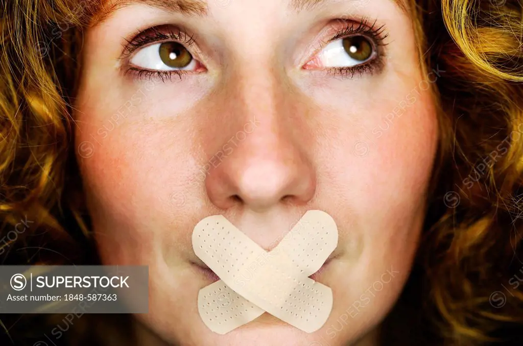 Woman with tape over her mouth, symbolic image for banned speech